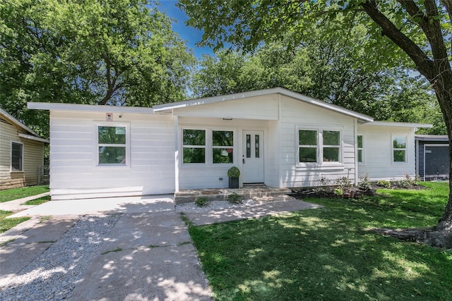 ranch-style house with a front lawn