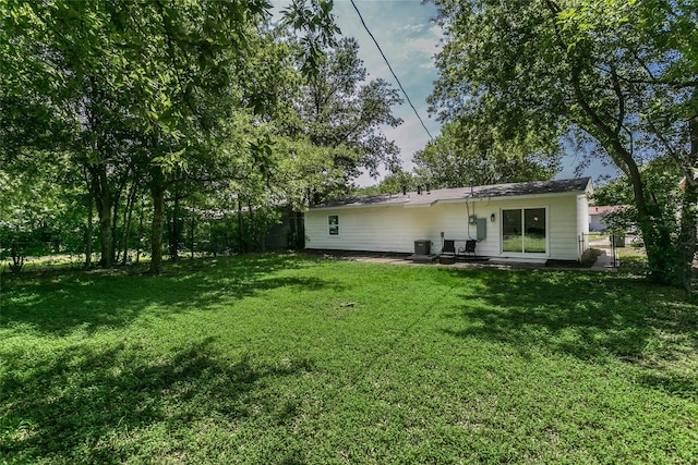 rear view of house with a lawn