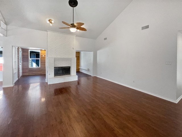 unfurnished living room featuring a fireplace, dark hardwood / wood-style floors, high vaulted ceiling, and ceiling fan