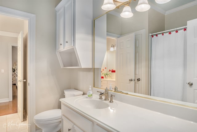 bathroom featuring vanity, ornamental molding, and toilet