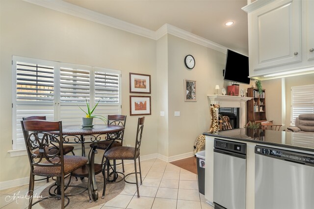 kitchen featuring dishwasher, light tile patterned flooring, white cabinets, and crown molding