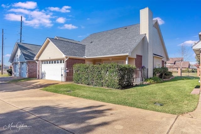 view of front of house featuring a garage and a front lawn