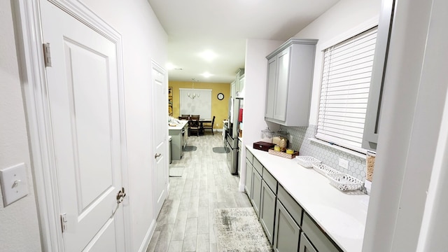 interior space with washing machine and clothes dryer, cabinets, and light hardwood / wood-style floors