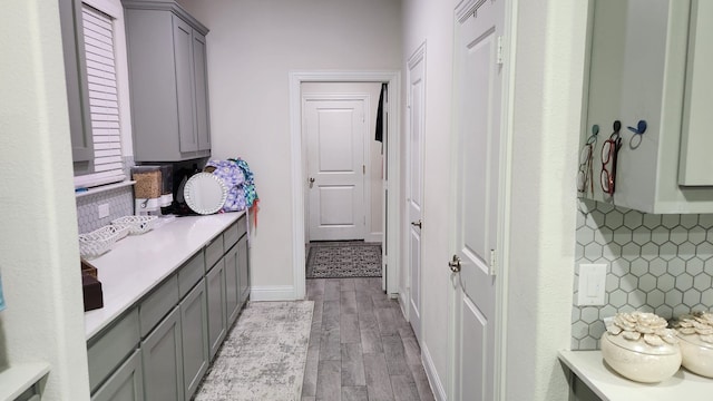 laundry room with light hardwood / wood-style flooring