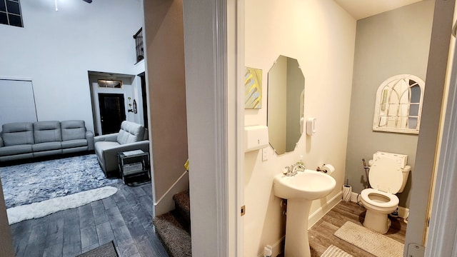 bathroom with hardwood / wood-style floors, toilet, and sink