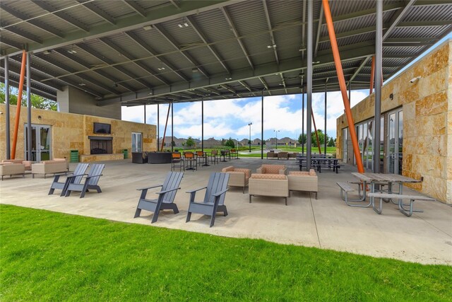 view of patio featuring an outdoor stone fireplace