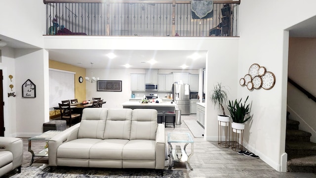 living room featuring light wood-type flooring and a chandelier