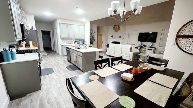 dining room featuring light hardwood / wood-style floors and an inviting chandelier