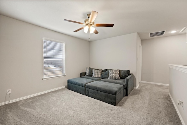 carpeted living room featuring ceiling fan