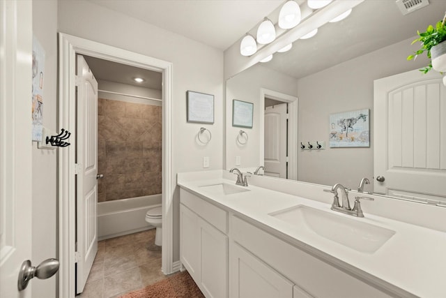 full bathroom with toilet, vanity, tile patterned flooring, and tiled shower / bath