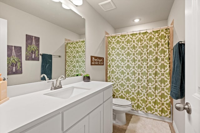 bathroom featuring tile patterned flooring, vanity, and toilet