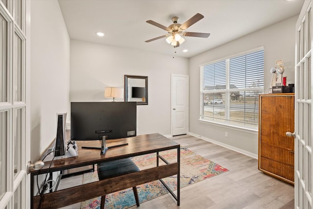 office featuring french doors, ceiling fan, and light hardwood / wood-style floors