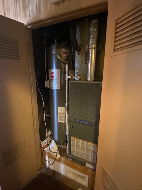 utility room featuring water heater