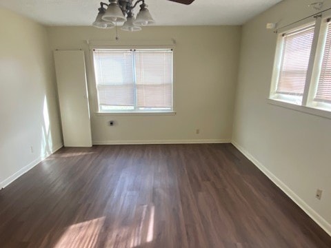 unfurnished room with dark hardwood / wood-style floors and ceiling fan