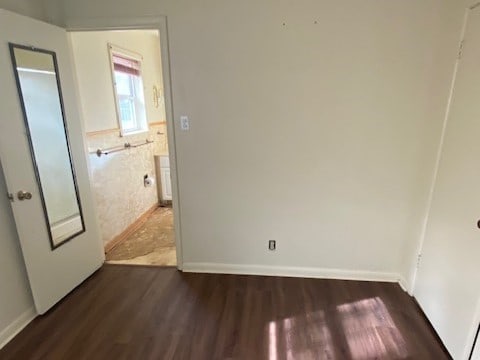 spare room with dark hardwood / wood-style floors