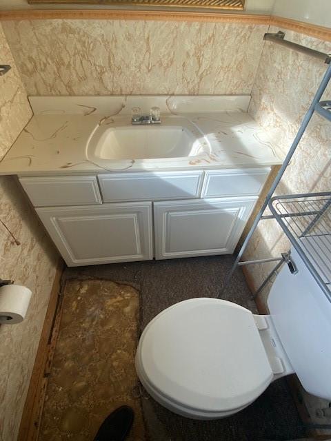 bathroom featuring vanity and toilet