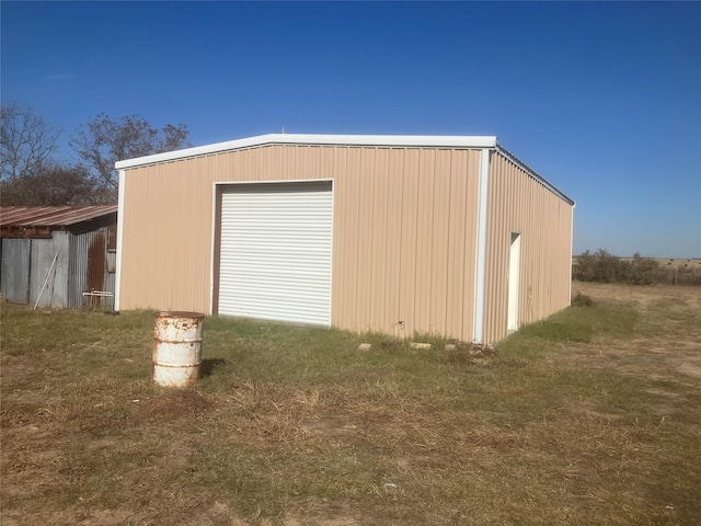 view of outbuilding featuring a lawn