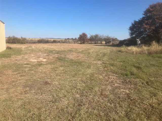 view of yard with a rural view