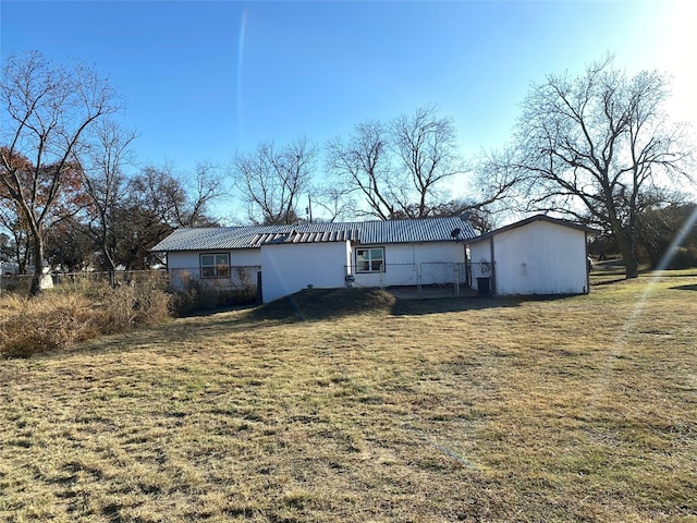 rear view of property featuring a yard