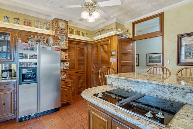 kitchen featuring black electric stovetop, tile patterned floors, stainless steel refrigerator with ice dispenser, ceiling fan, and ornamental molding