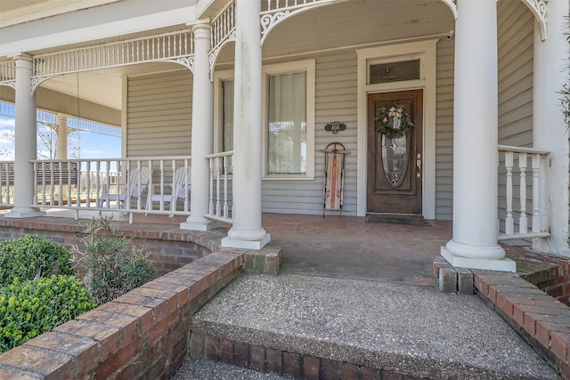 view of exterior entry featuring a porch