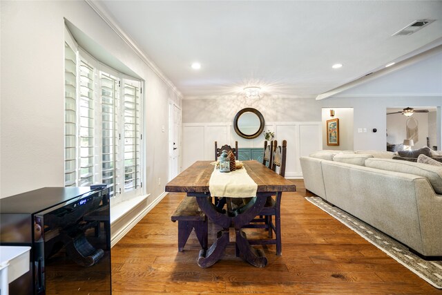 dining room with crown molding, hardwood / wood-style floors, and ceiling fan