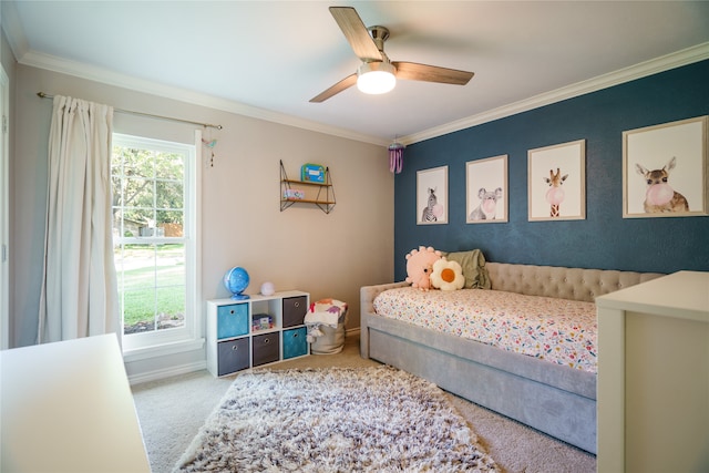 carpeted bedroom with ceiling fan and ornamental molding