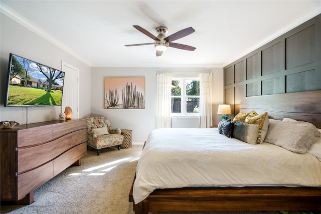 carpeted bedroom with ceiling fan and ornamental molding