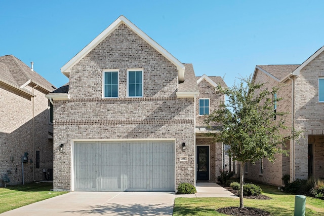 view of front property featuring a garage and a front yard