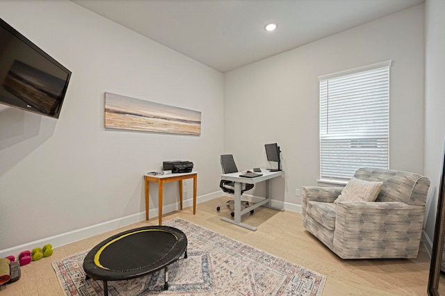 home office with light hardwood / wood-style floors