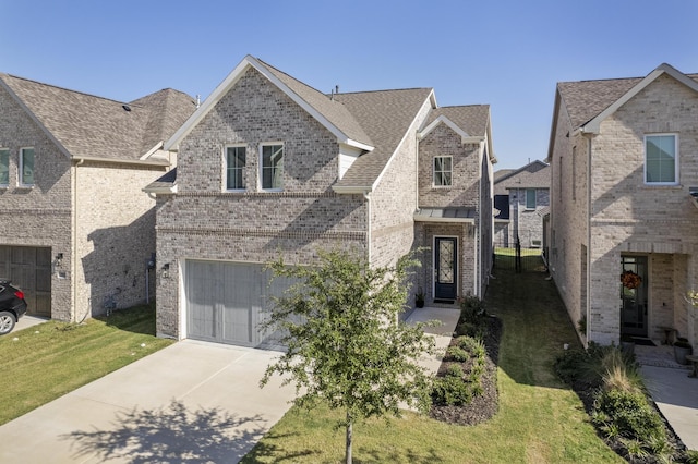 view of front facade with a garage and a front lawn