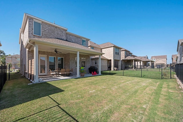 back of property featuring a lawn, ceiling fan, and a patio