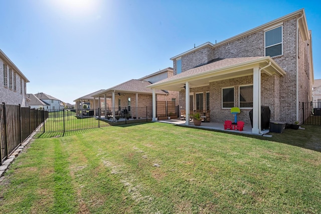 back of property featuring a patio, ceiling fan, and a lawn