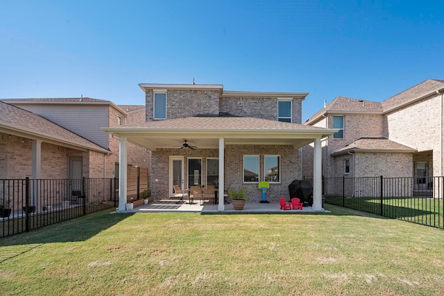 back of property with a patio, ceiling fan, and a lawn