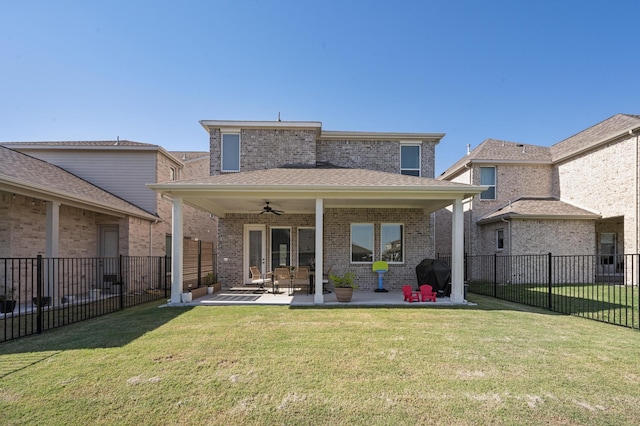 back of house featuring ceiling fan, a yard, and a patio