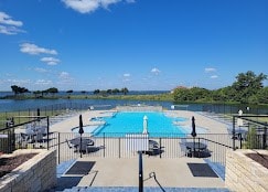 view of swimming pool featuring a patio area and a water view