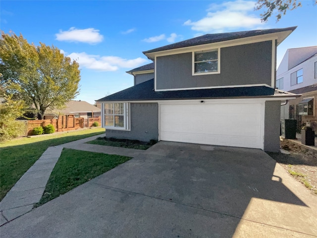 view of front property featuring central AC, a front lawn, and a garage