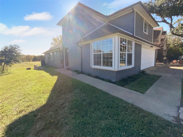 view of side of home with a yard and a garage