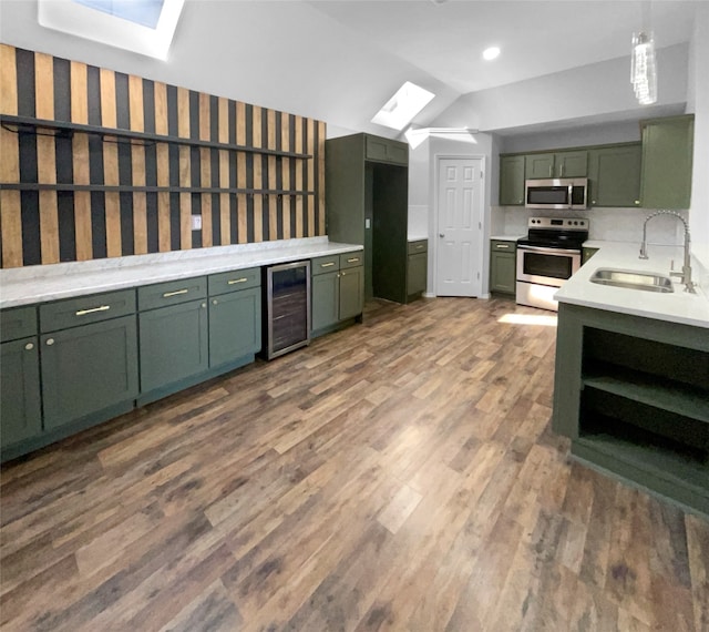 kitchen featuring sink, stainless steel appliances, wine cooler, dark hardwood / wood-style floors, and green cabinetry