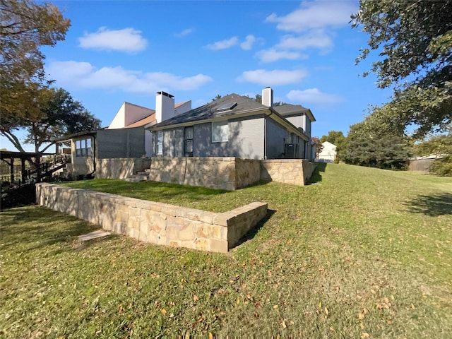 view of side of property with a yard