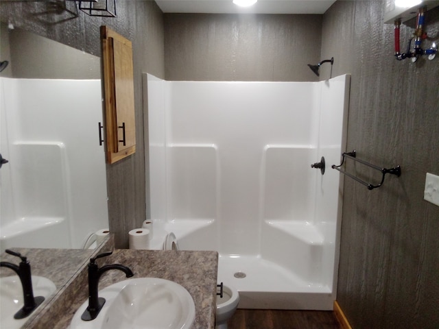 bathroom featuring a shower, wood-type flooring, vanity, and toilet