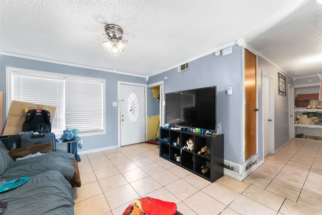 tiled living room with a textured ceiling and ornamental molding