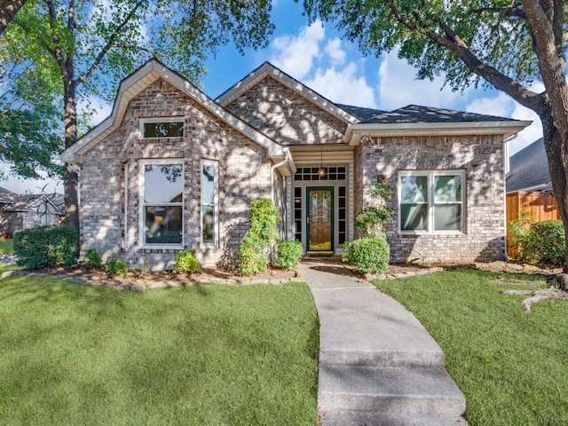 view of front of home with brick siding and a front yard