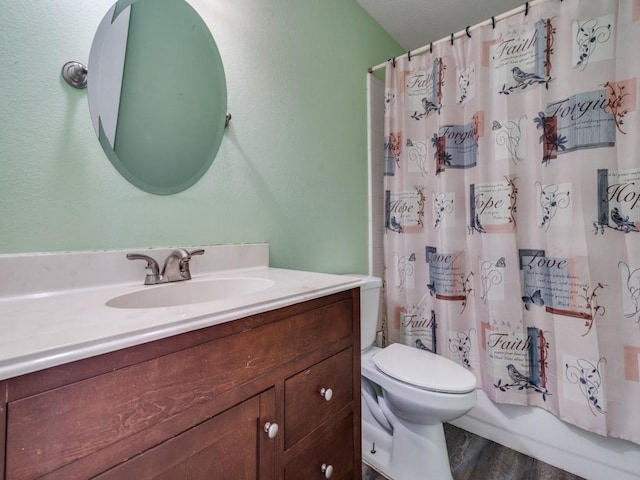 full bath with toilet, shower / tub combo with curtain, wood finished floors, and vanity