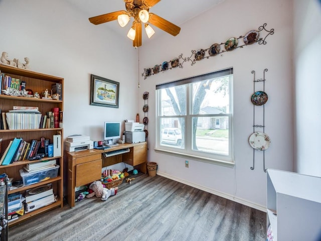 home office with a ceiling fan, baseboards, and wood finished floors