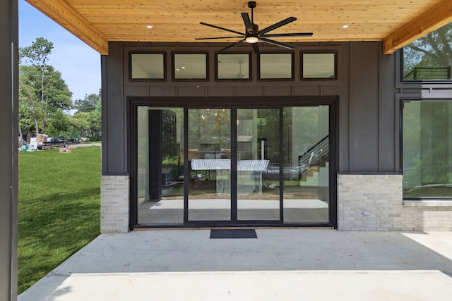 entrance to property featuring a lawn