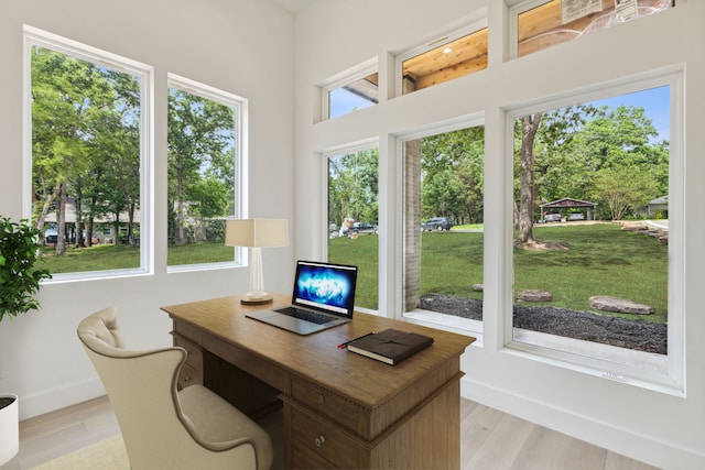 office area with light wood-type flooring and a wealth of natural light