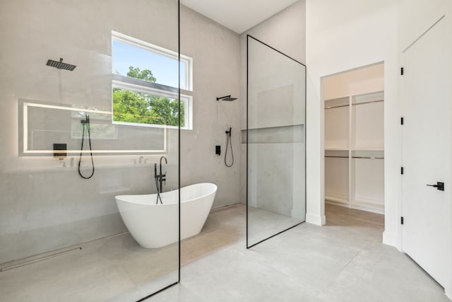 bathroom with concrete flooring and independent shower and bath