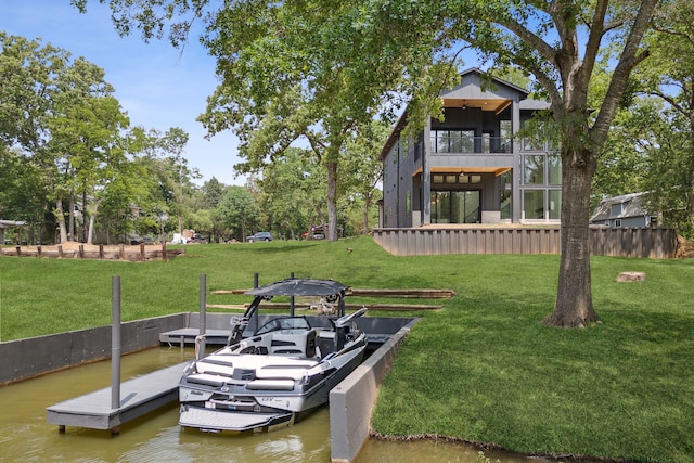 view of dock featuring a balcony, a lawn, and a water view