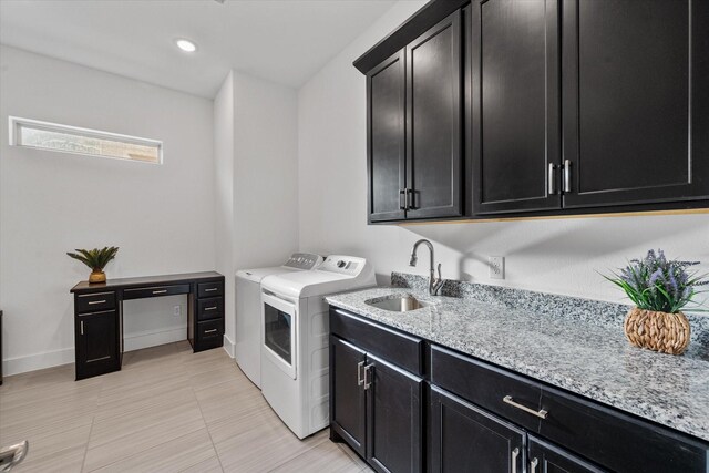 laundry area with recessed lighting, a sink, baseboards, cabinet space, and washer and clothes dryer